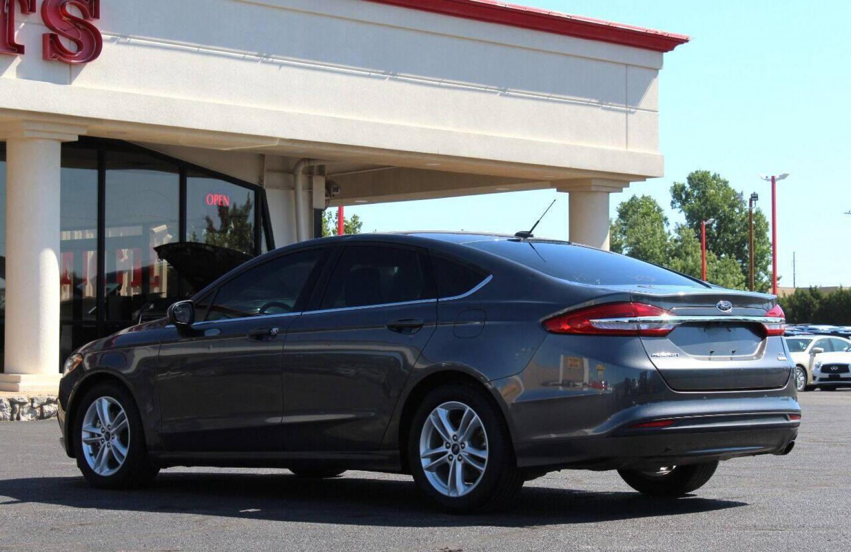 2018 Gray Ford Fusion SE (3FA6P0HD6JR) with an 1.5L L4 DOHC 16V engine, 6A transmission, located at 4301 NW 39th , Oklahoma City, OK, 73112, (405) 949-5600, 35.512135, -97.598671 - NO DRIVERS LICENCE NO - FULL COVERAGE INSURANCE - NO CREDIT CHECK. COME ON OVER TO SUPERSPORTS AND TAKE A LOOK AND TEST DRIVE. PLEASE GIVE US A CALL AT (405) 949-5600. NO LICENCIA DE MANEJAR - NO SEGURO DE COBERTURA TOTAL - NO VERIFICACION DE CREDITO. POR FAVOR VENGAN A SUPERSPORTS, ECH - Photo#5