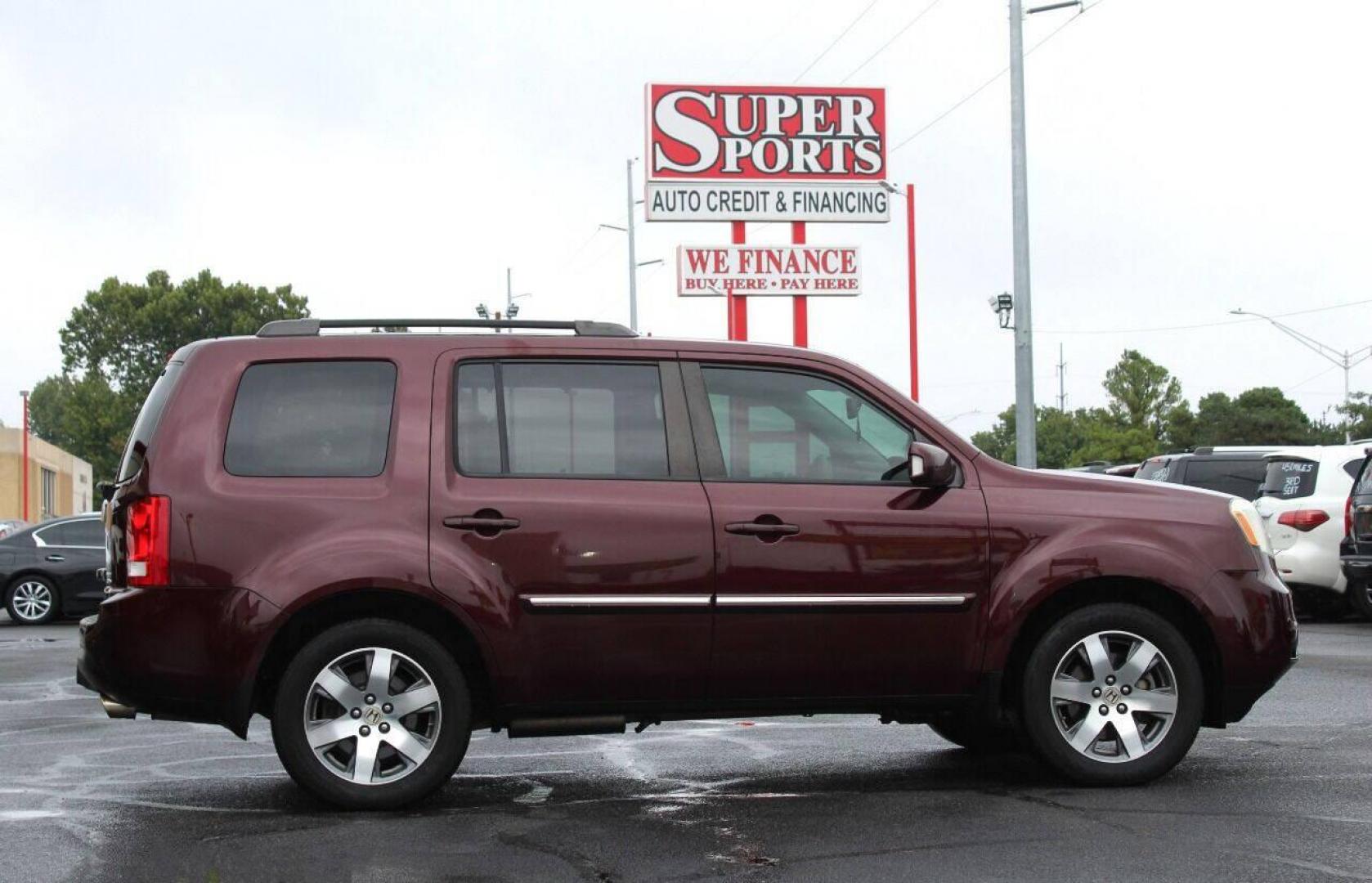 2014 Maroon Honda Pilot Touring 4WD 5-Spd AT with DVD (5FNYF4H99EB) with an 3.5L V6 SOHC 24V engine, 5-Speed Automatic transmission, located at 4301 NW 39th , Oklahoma City, OK, 73112, (405) 949-5600, 35.512135, -97.598671 - NO DRIVERS LICENSE - NO FULL COVERAGE INSURANCE - NO CREDIT CHECK. COME ON OVER TO SUPERSPORTS AND TAKE A LOOK AND TEST DRIVE. PLEASE GIVE US A CALL AT (405) 949-5600. NO LICENCIA DE MANEJAR - NO SEGURO DE COBERTURA TOTAL - NO VERIFICACION DE CREDITO. POR FAVOR VENGAN A SUPERSPORTS, E - Photo#3