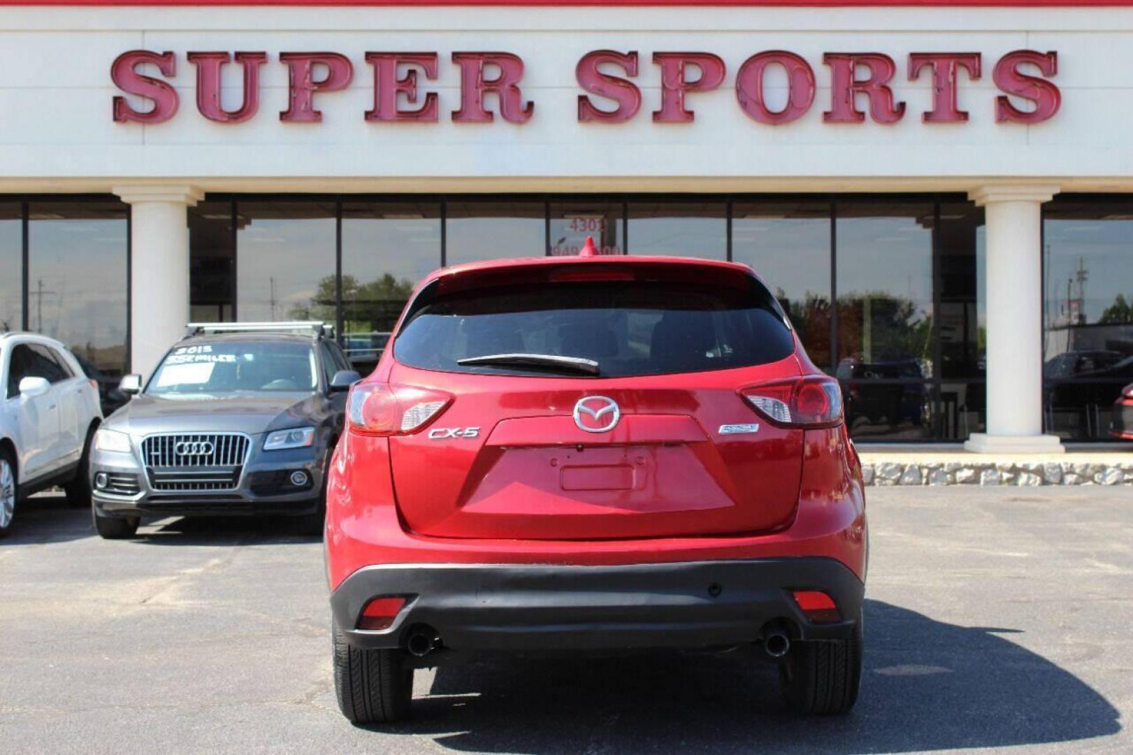 2015 Red Mazda CX-5 Touring (JM3KE2CYXF0) with an 2.5L L4 DOHC 16V engine, 6-Speed Automatic transmission, located at 4301 NW 39th , Oklahoma City, OK, 73112, (405) 949-5600, 35.512135, -97.598671 - NO DRIVERS LICENCE - NO FULL COVERAGE INSURANCE - NO CREDIT CHECK. COME ON OVER TO SUPERSPORTS AND TAKE A LOOK AND TEST DRIVE. PLEASE GIVE US A CALL AT (405) 949-5600. NO LICENCIA DE MANEJAR - NO SEGURO DE COBERTURA TOTAL - NO VERIFICACION DE CREDITO. POR FAVOR VENGAN A SUPERSPO - Photo#4